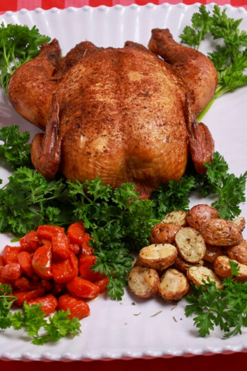 Golden-brown smoked whole chicken with crispy skin