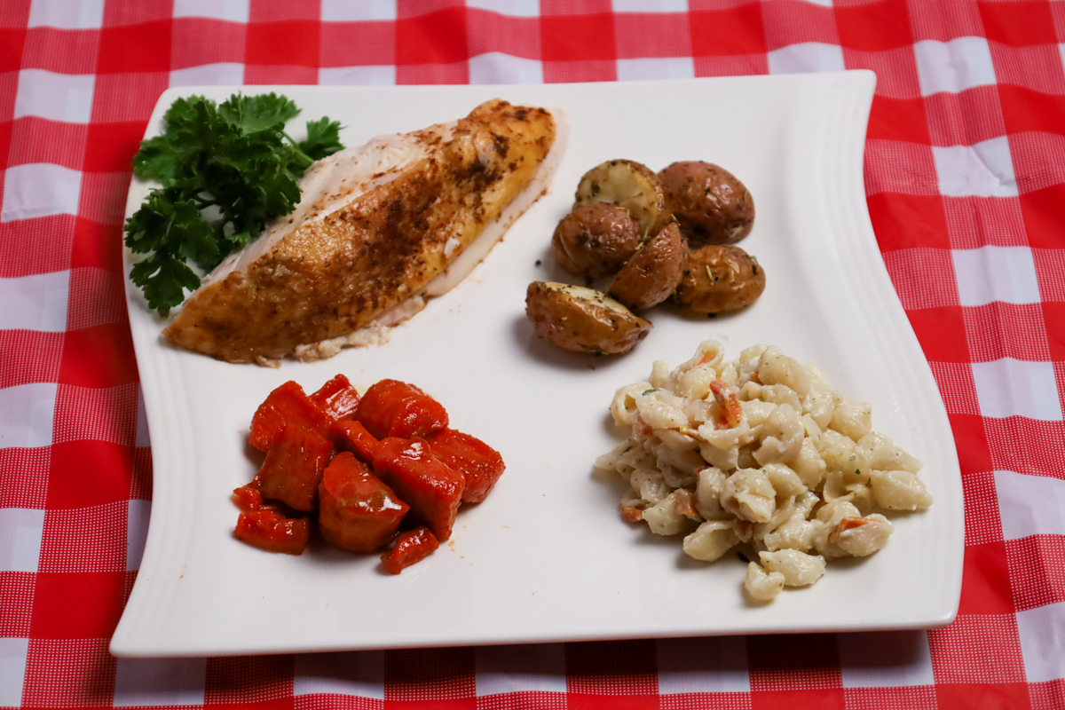 Perfectly smoked whole chicken served with a variety of delicious sides.