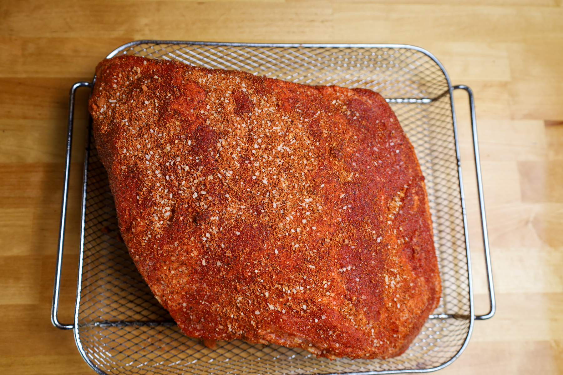 Seasoned Boston butt pork, prepared with a custom spice rub for optimal flavor.