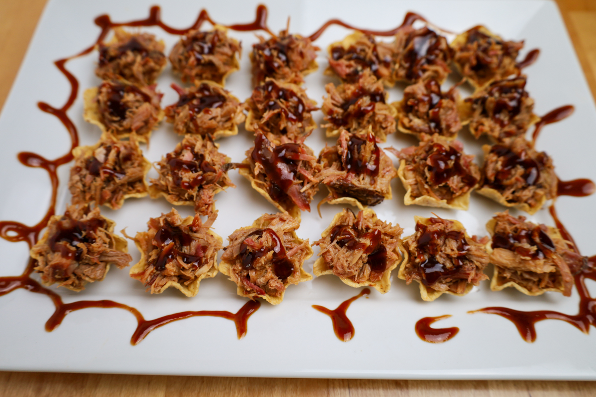 Corn chips topped with tender pulled pork and barbecue sauce