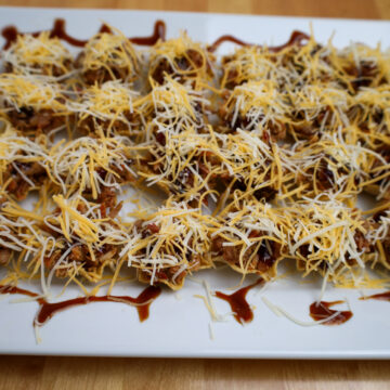 Delicious smoked pulled pork bites, seasoned and ready for the oven.