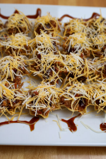 Delicious smoked pulled pork bites, seasoned and ready for the oven.
