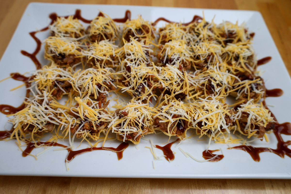 Delicious smoked pulled pork bites, seasoned and ready for the oven.