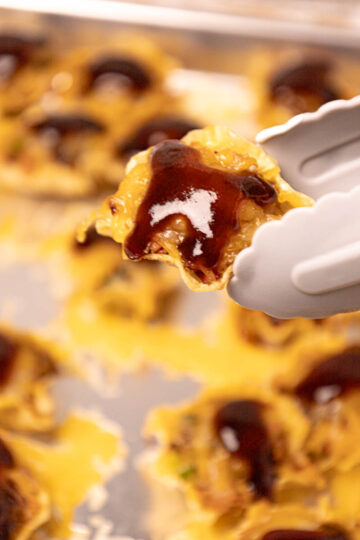 A close-up of glazed pork bites, golden brown and sprinkled with fresh herbs.
