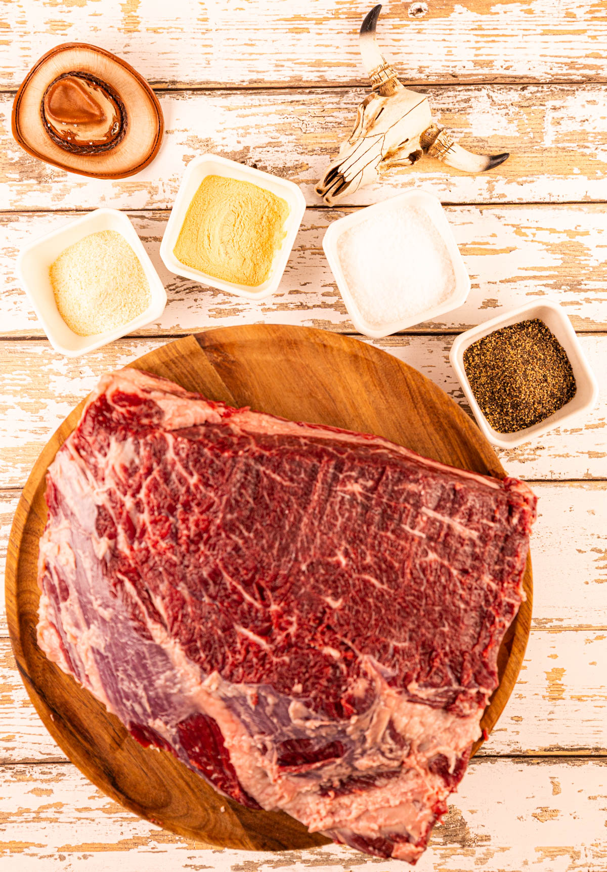 Raw beef dino ribs with the fat trimmed, before being seasoned, ready to be smoked.