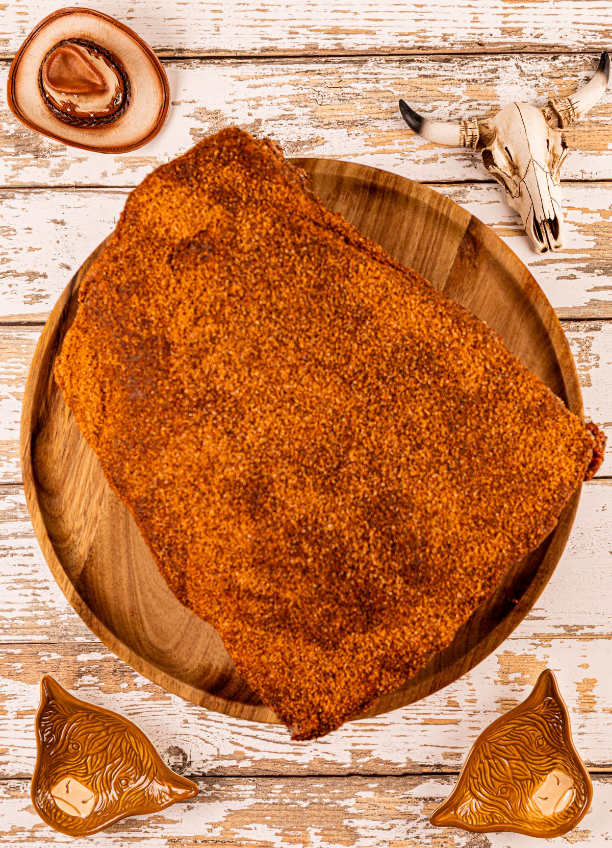 Seasoned beef dino ribs, coated in a rich spice rub, ready to go into the smoker for a slow cook.